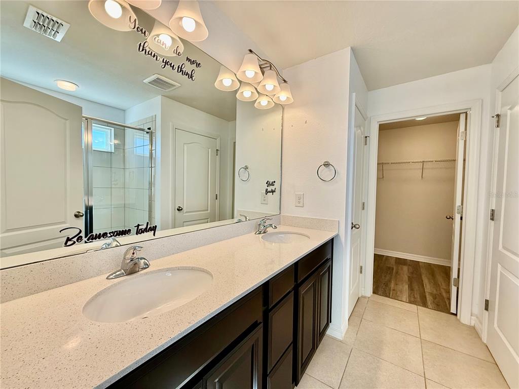 14207 Poke Ridge Drive Riverview, FL 33579 - Photo 18 of 34 a bathroom with a sink double vanity granite tub and a mirror