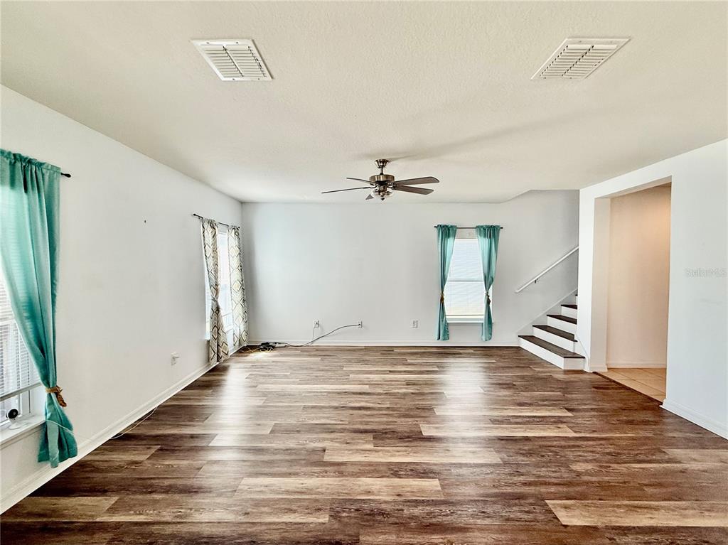 14207 Poke Ridge Drive Riverview, FL 33579 - Photo 5 of 34 a view of an empty room with wooden floor and a window