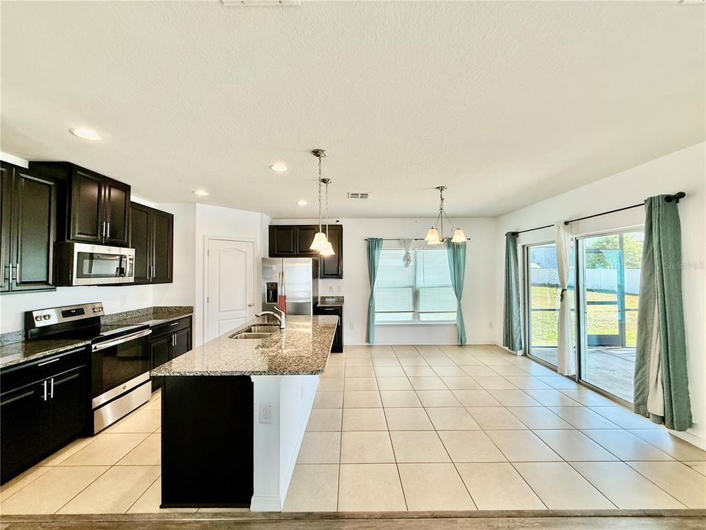14207 Poke Ridge Drive Riverview, FL 33579 - Photo 7 of 34 a kitchen with a sink stove and cabinets