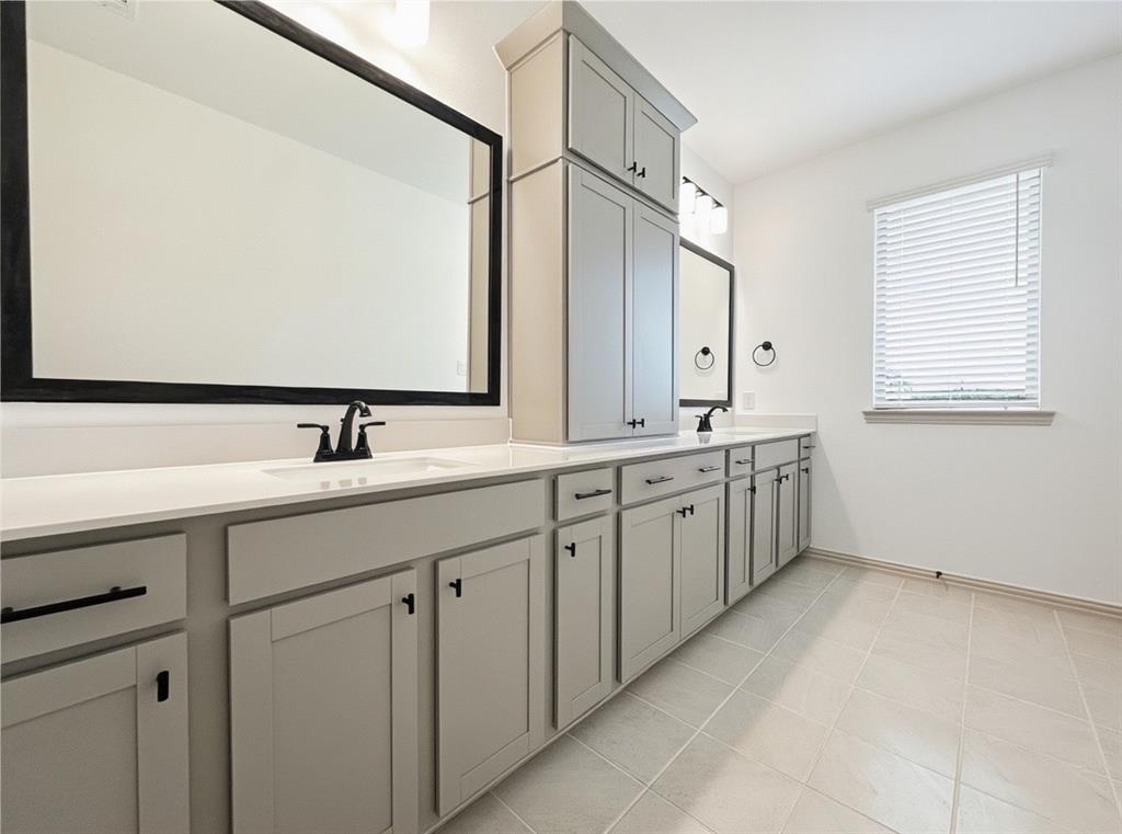 2837 Bluejack Road McKinney, TX 75071 - Photo 22 of 40 a bathroom with a double vanity sink and mirror