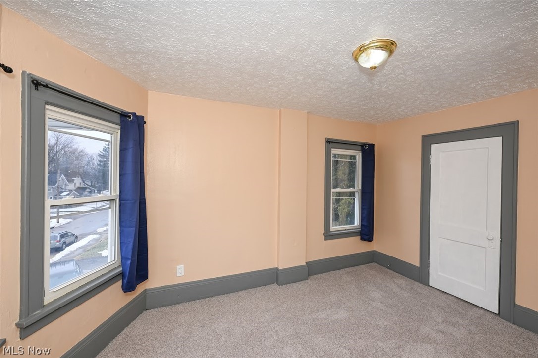 77 West Mildred Avenue Akron, OH 44310 - Photo 29 of 40 Empty room featuring carpet and a textured ceiling
