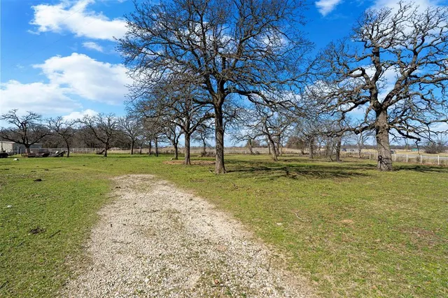 a view of yard with swimming pool and trees
