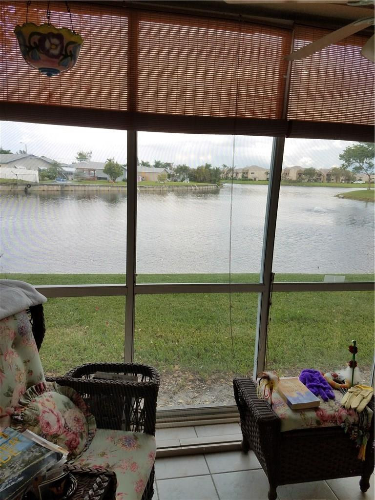 9587 Weldon Circle, Unit 110 Tamarac, FL 33321 - Photo 7 of 7 a view of an outdoor sitting area with furniture and a lake view