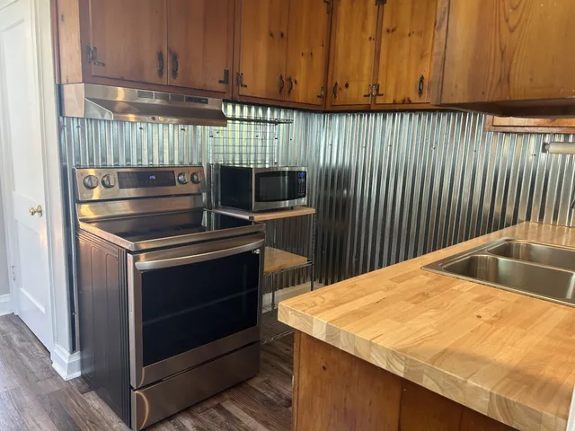 a kitchen with a stove and a microwave oven
