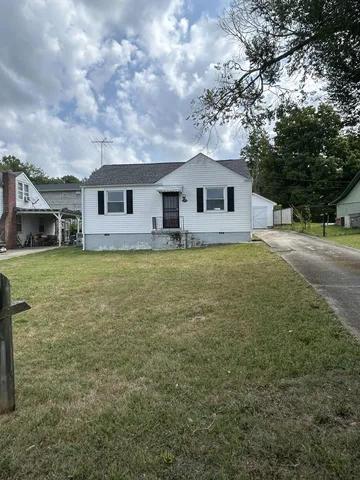 a house that has a tree in front of it