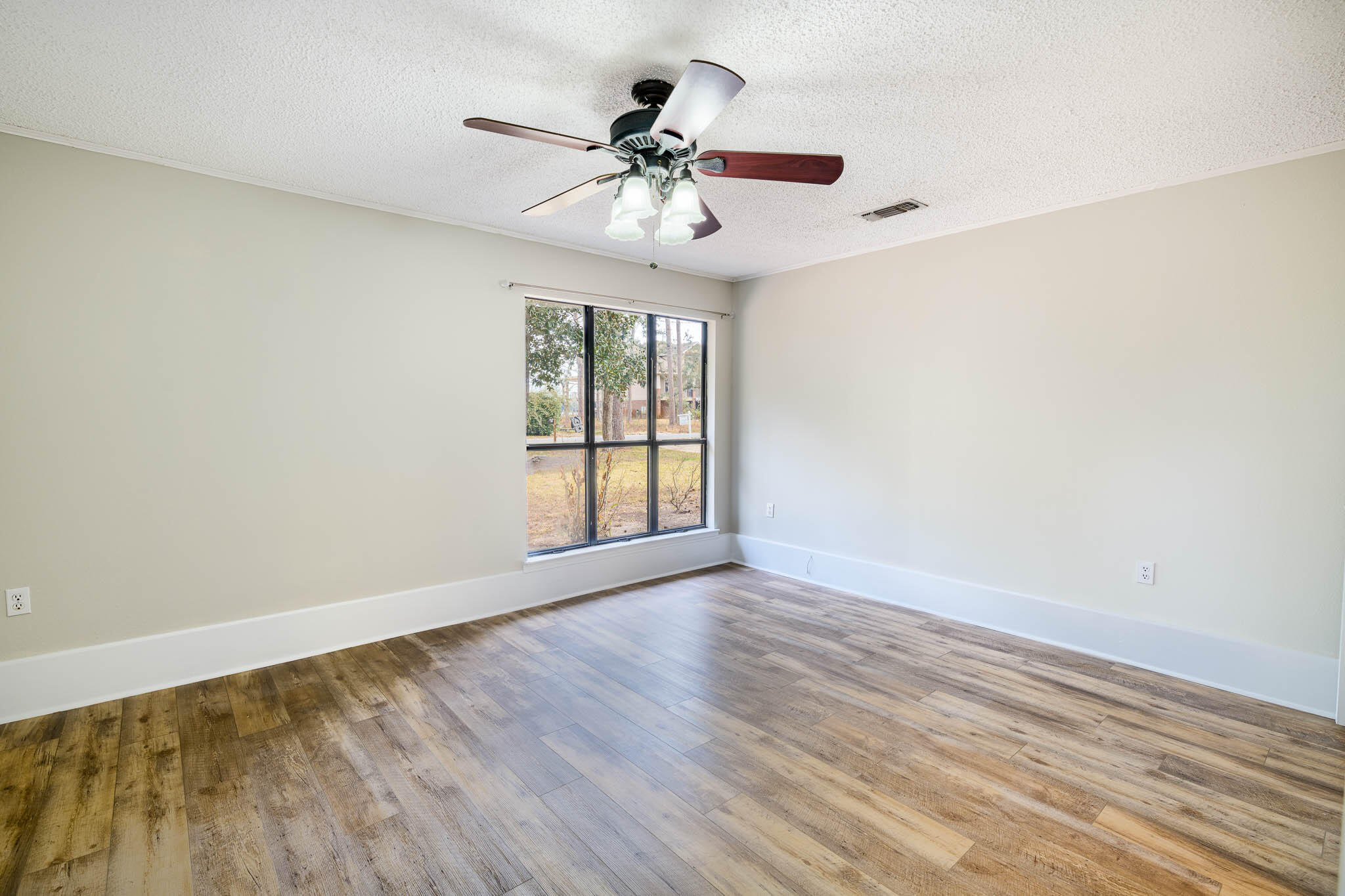 1688 Vine Avenue Niceville, FL 32578 - Photo 22 of 32 wooden floor in an empty room with a window