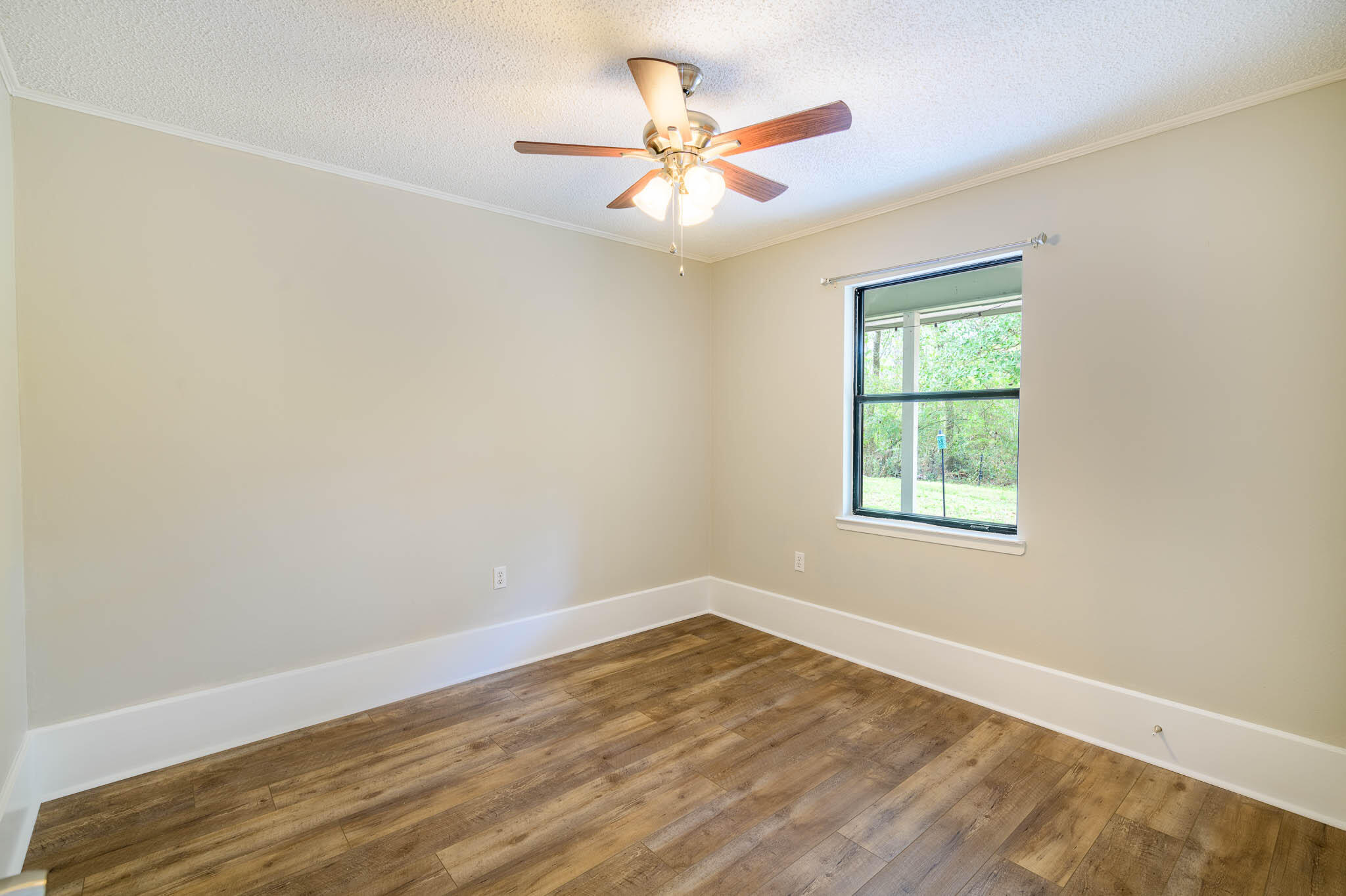 1688 Vine Avenue Niceville, FL 32578 - Photo 24 of 32 an empty room with a window and a fan