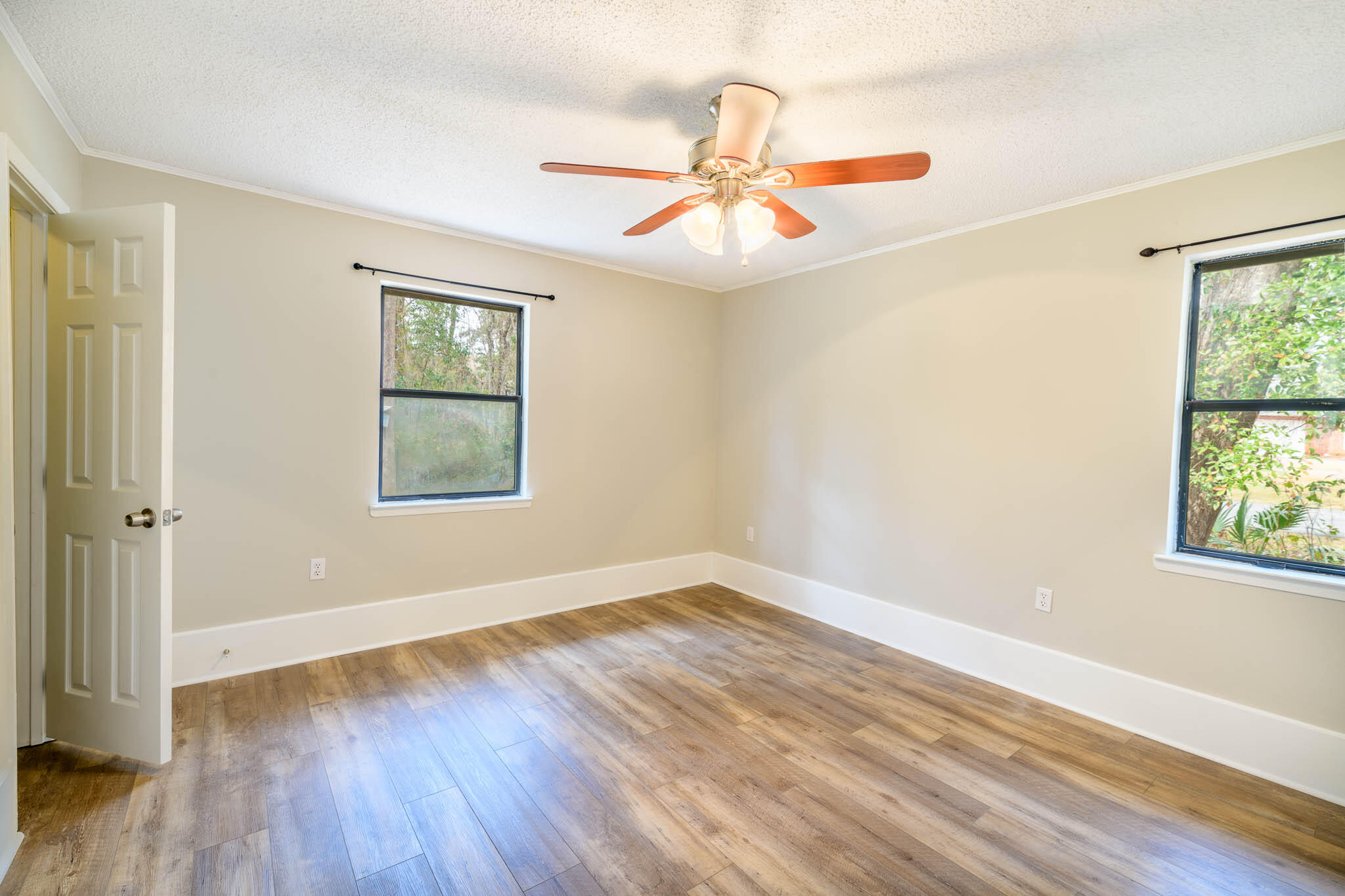 1688 Vine Avenue Niceville, FL 32578 - Photo 25 of 32 a view of an empty room with wooden floor and a window
