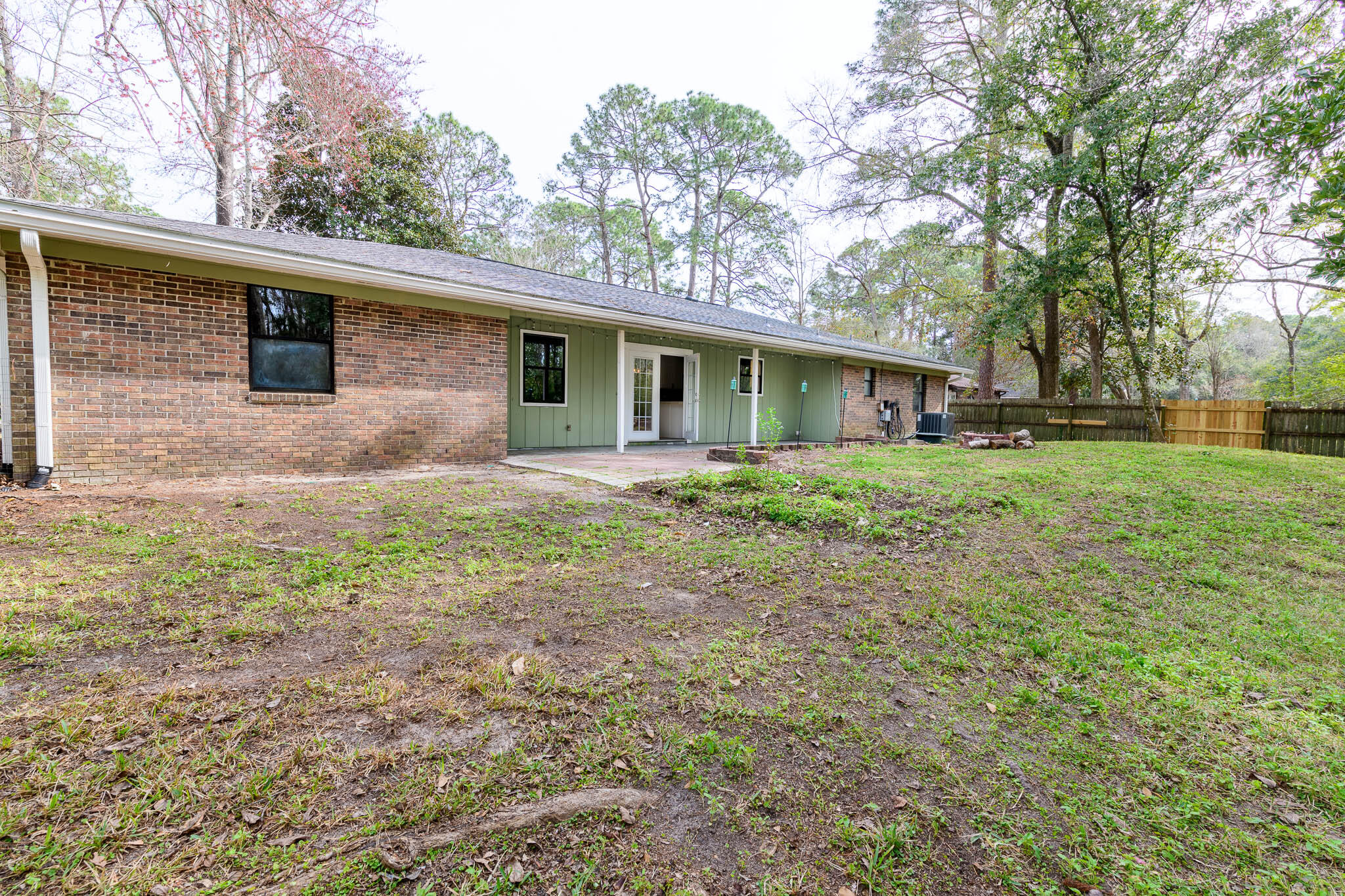 1688 Vine Avenue Niceville, FL 32578 - Photo 31 of 32 a backyard of a house with plants and large tree