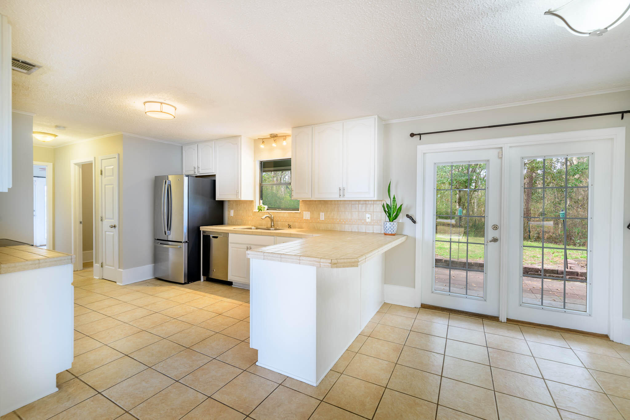 1688 Vine Avenue Niceville, FL 32578 - Photo 6 of 32 a large kitchen with a stove a refrigerator a sink dishwasher with a oven and cabinets