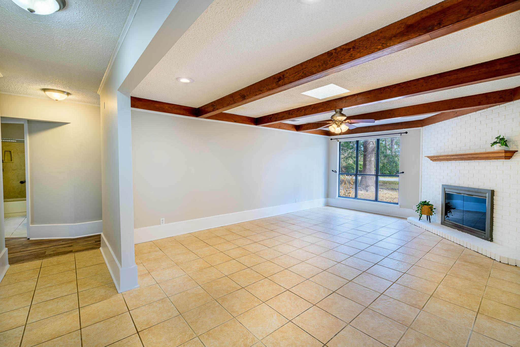 1688 Vine Avenue Niceville, FL 32578 - Photo 7 of 32 a view of an empty room with a fireplace and a window