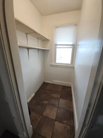 a view of a room with an empty space and window