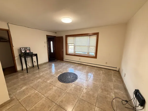 a view of a room with wooden floor and window