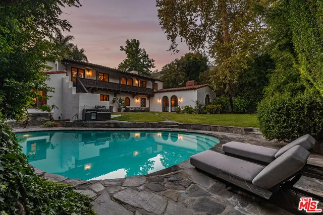 a view of a swimming pool with lounge chairs in patio
