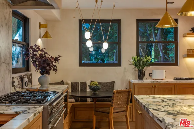 a kitchen with a stove and a wooden table