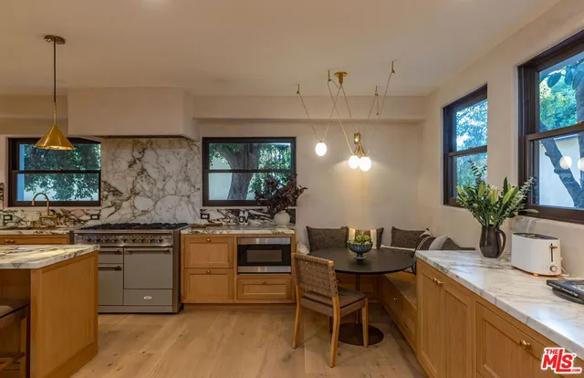 a kitchen with a table and chairs in it