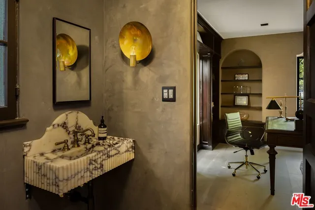 a living room with furniture and a mirror