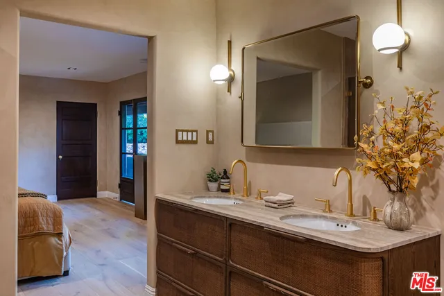 a bathroom with a double vanity sink and a mirror