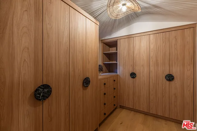 a spacious bedroom with a bed and glass window