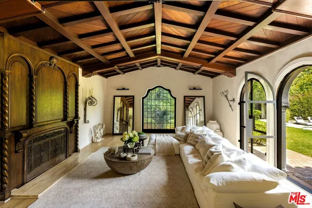 a living room with furniture fireplace and flat screen tv