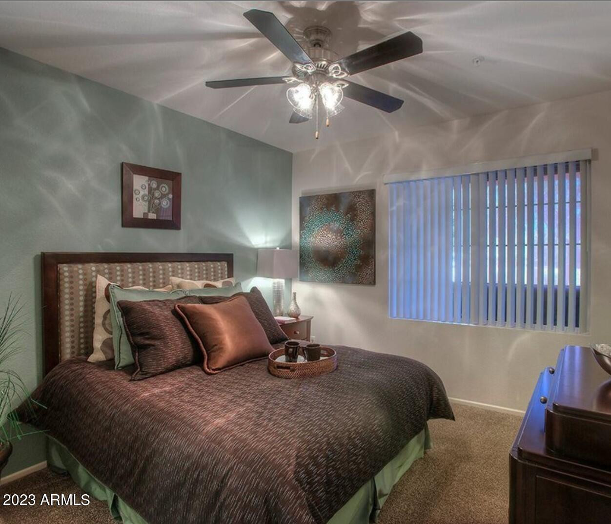 110 West Bell Road, Unit 12 Phoenix, AZ 85023 - Photo 6 of 15 a bedroom with a bed and a chandelier