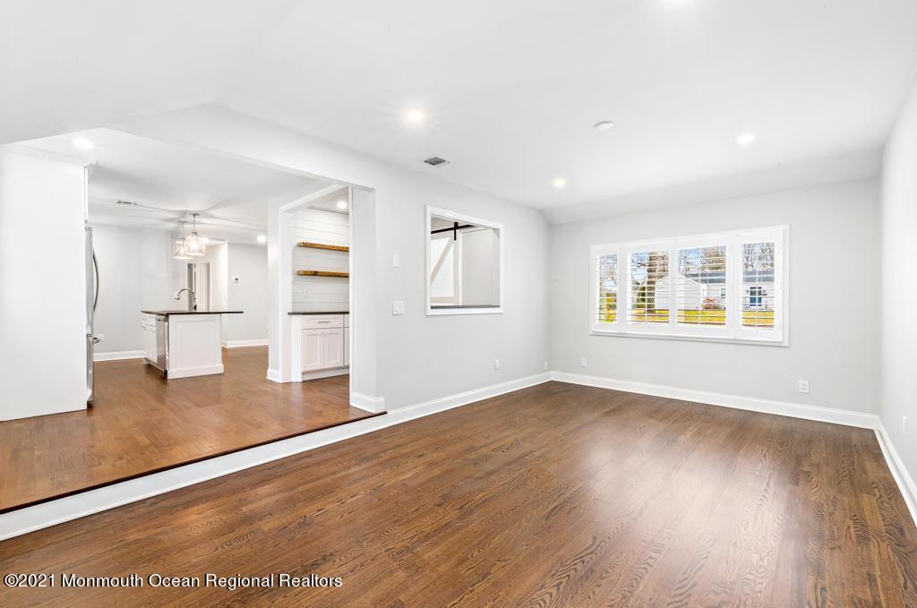 495 Branch Avenue Little Silver, NJ 07739 - Photo 14 of 26 a view of empty room with wooden floor and kitchen view