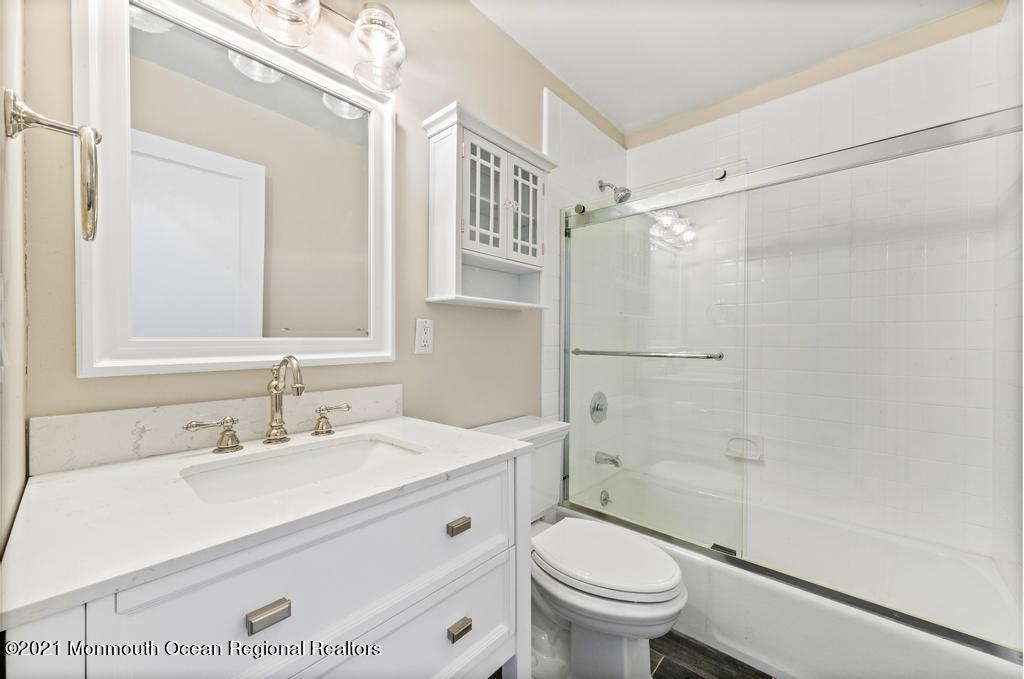 495 Branch Avenue Little Silver, NJ 07739 - Photo 25 of 26 a bathroom with a sink a toilet and shower