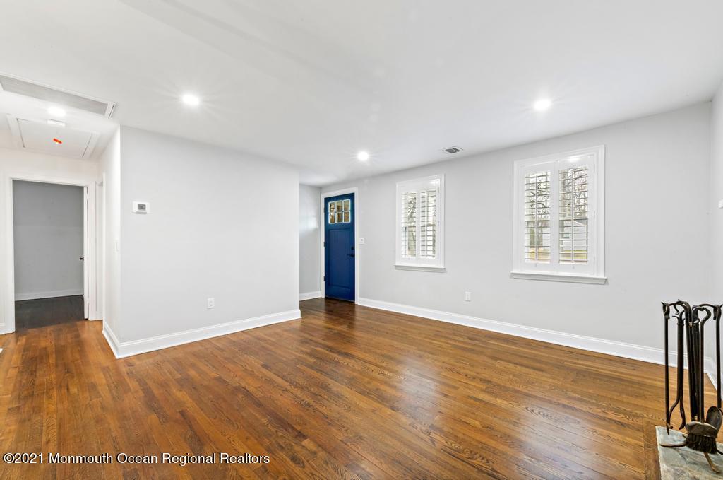 495 Branch Avenue Little Silver, NJ 07739 - Photo 3 of 26 a view of an empty room with wooden floor and a window