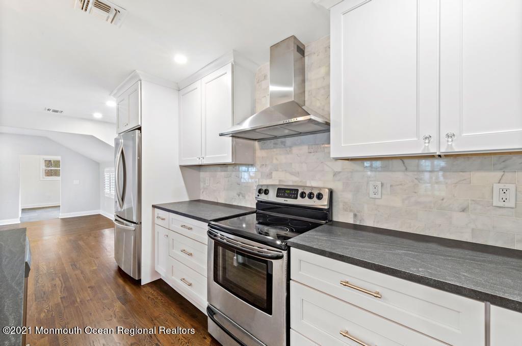 495 Branch Avenue Little Silver, NJ 07739 - Photo 6 of 26 a kitchen with stainless steel appliances granite countertop a stove and a refrigerator