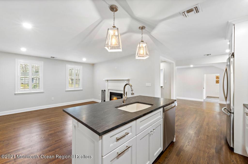 495 Branch Avenue Little Silver, NJ 07739 - Photo 8 of 26 a kitchen with a sink chandelier and wooden floor