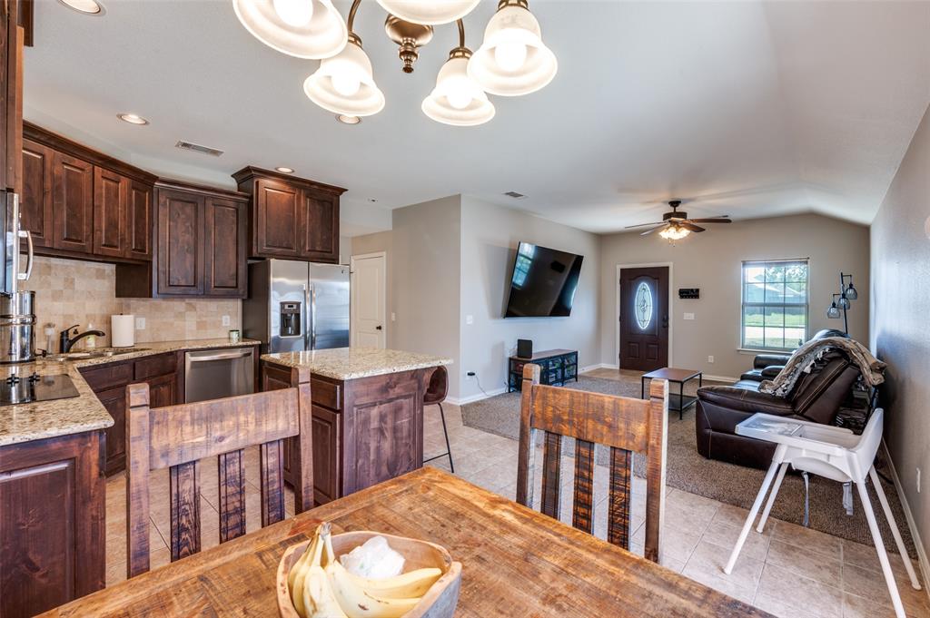 508 Copenhavr Street Pilot Point, TX 76258 - Photo 11 of 25 a large kitchen with lots of counter space a sink appliances and dining table