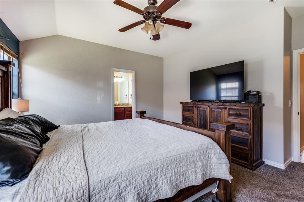 508 Copenhavr Street Pilot Point, TX 76258 - Photo 16 of 25 a bedroom with a bed and a flat screen tv