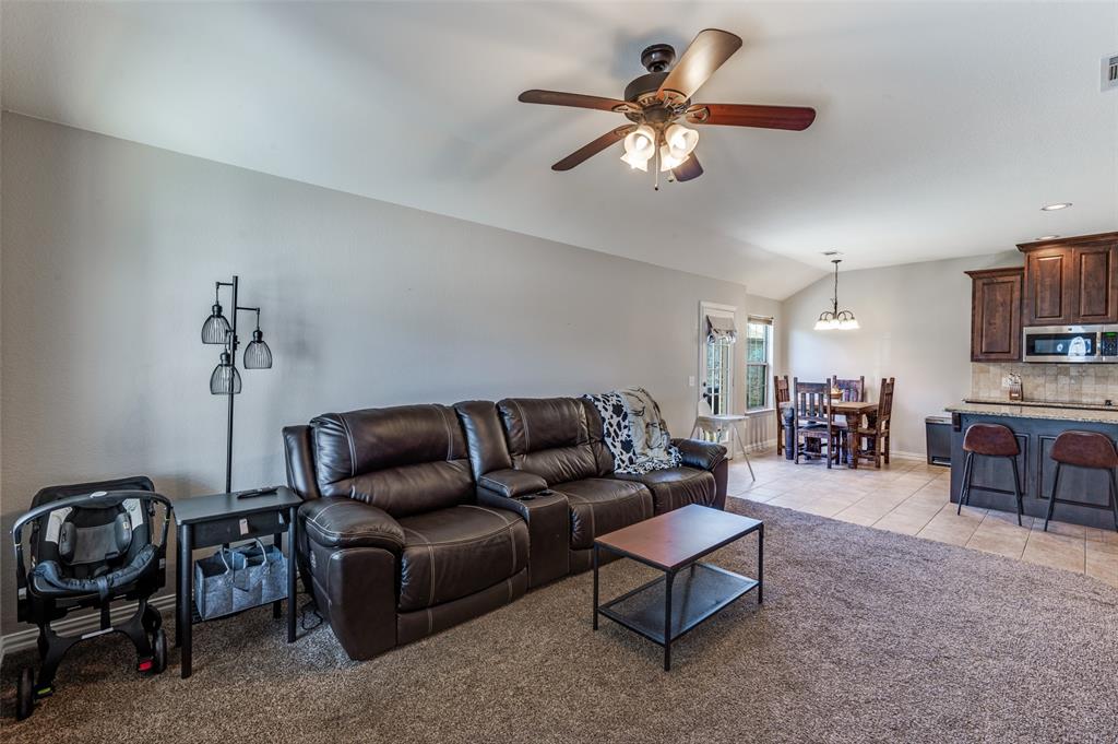 508 Copenhavr Street Pilot Point, TX 76258 - Photo 5 of 25 a living room with furniture a chandelier and a flat screen tv
