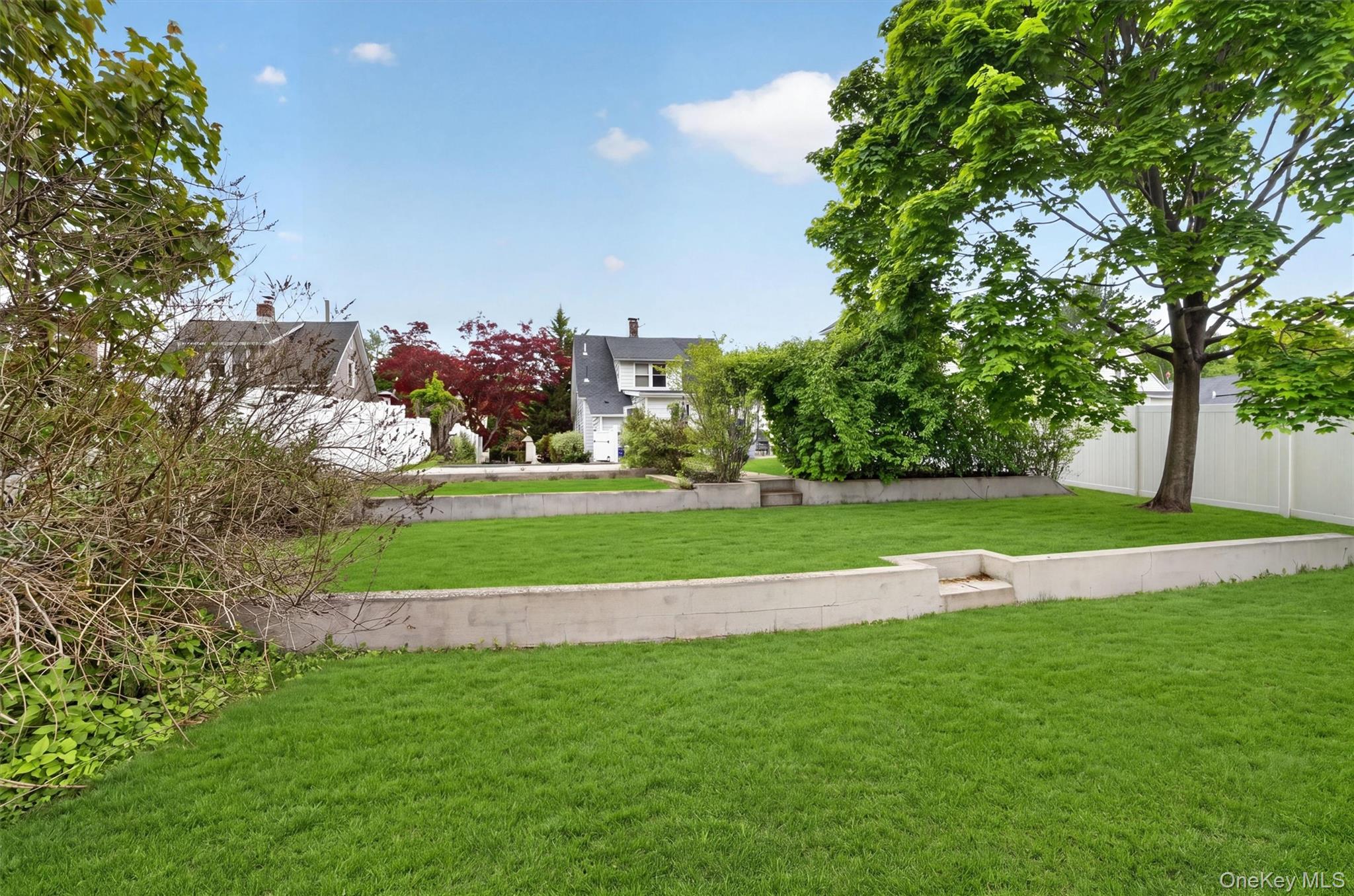658 Ridge Street Peekskill, NY 10566 - Photo 38 of 44 Expansive lawn area featuring a tiered design with concrete retaining walls.