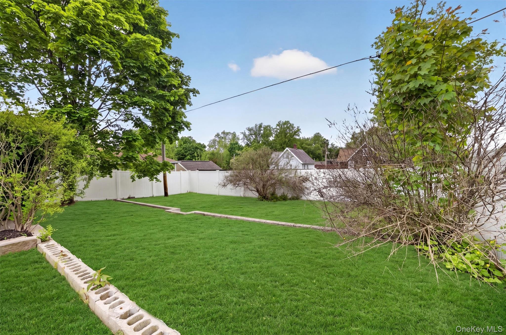 658 Ridge Street Peekskill, NY 10566 - Photo 39 of 44 Expansive lawn area featuring a tiered design with concrete retaining walls.
