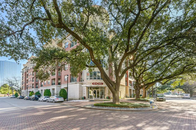a front view of a building with trees
