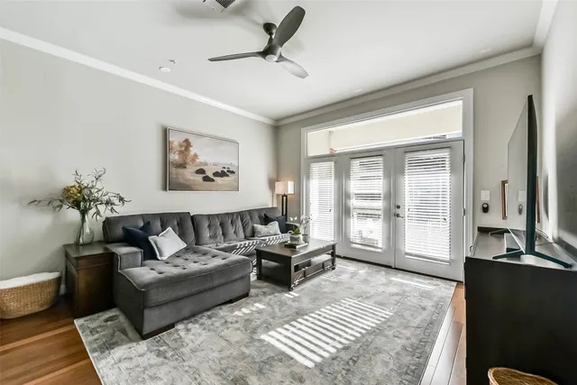 a kitchen with stainless steel appliances a dining table chairs stove refrigerator and cabinets