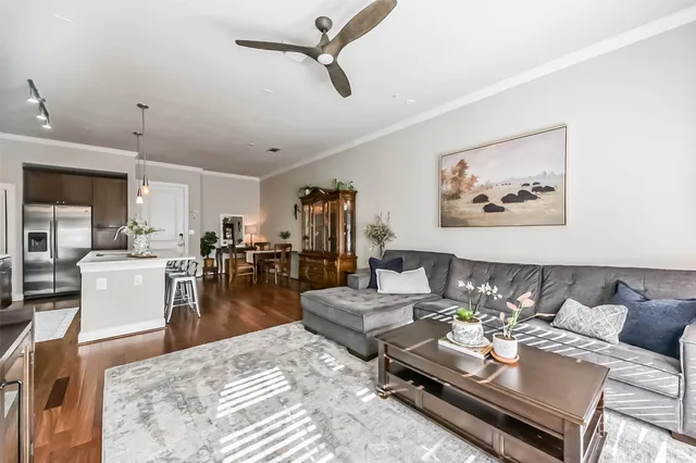 a living room with furniture and large windows
