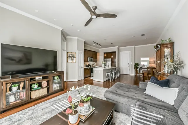 a living room with furniture and wooden floor