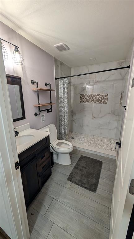 18312 Hollister Road Orlando, FL 32820 - Photo 9 of 10 a bathroom with a sink a toilet a mirror and shower