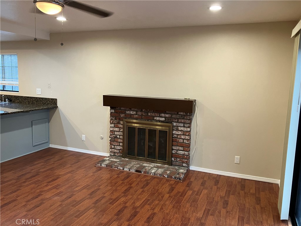 19933 Ralph Street Walnut, CA 91789 - Photo 31 of 77 an empty room with wooden floor and a fireplace
