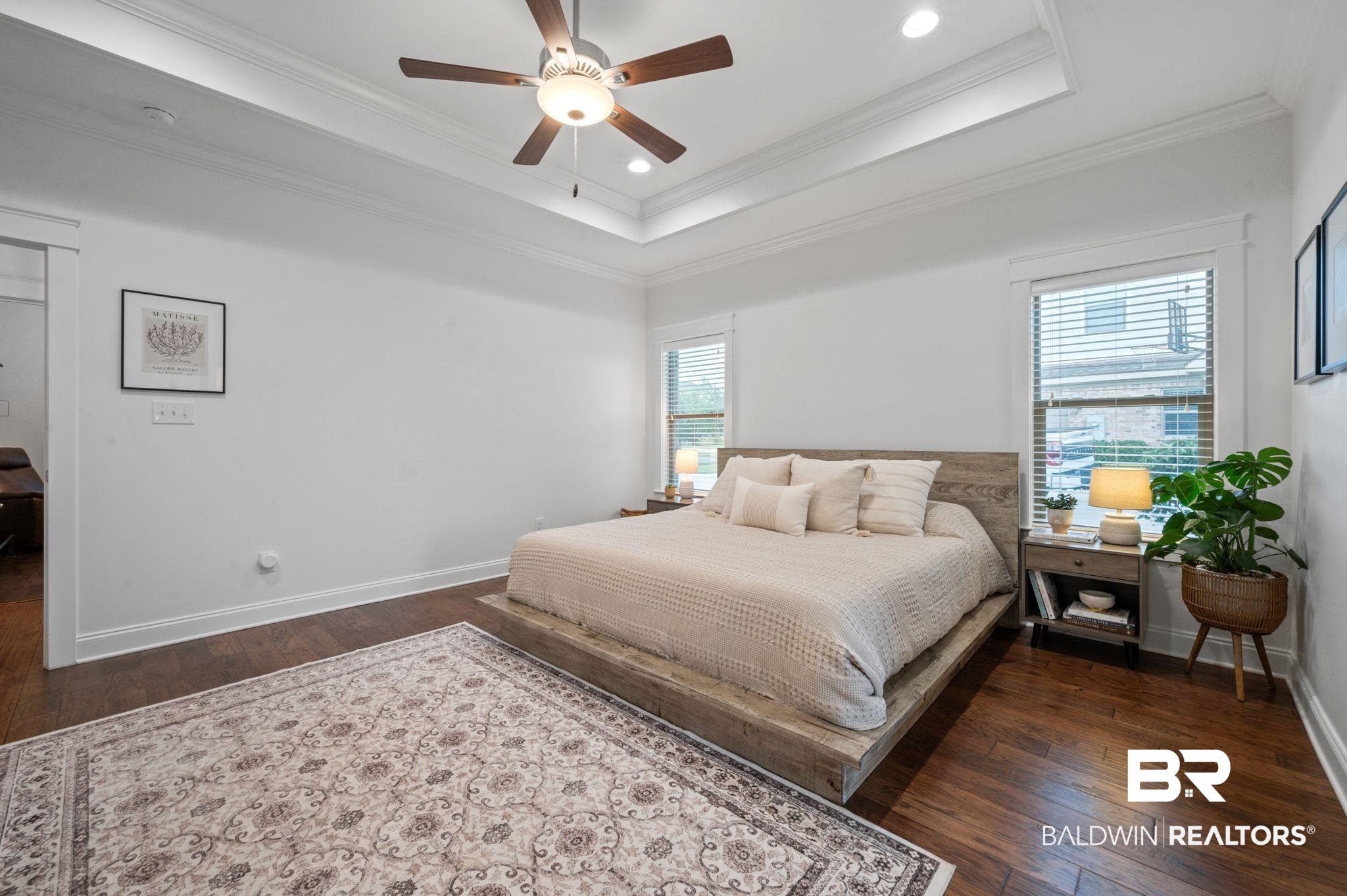 418 Fortune Drive Fairhope, AL 36532 - Photo 22 of 63 Bedroom with dark wood-type flooring, a raised ceiling, crown molding, and ceiling fan