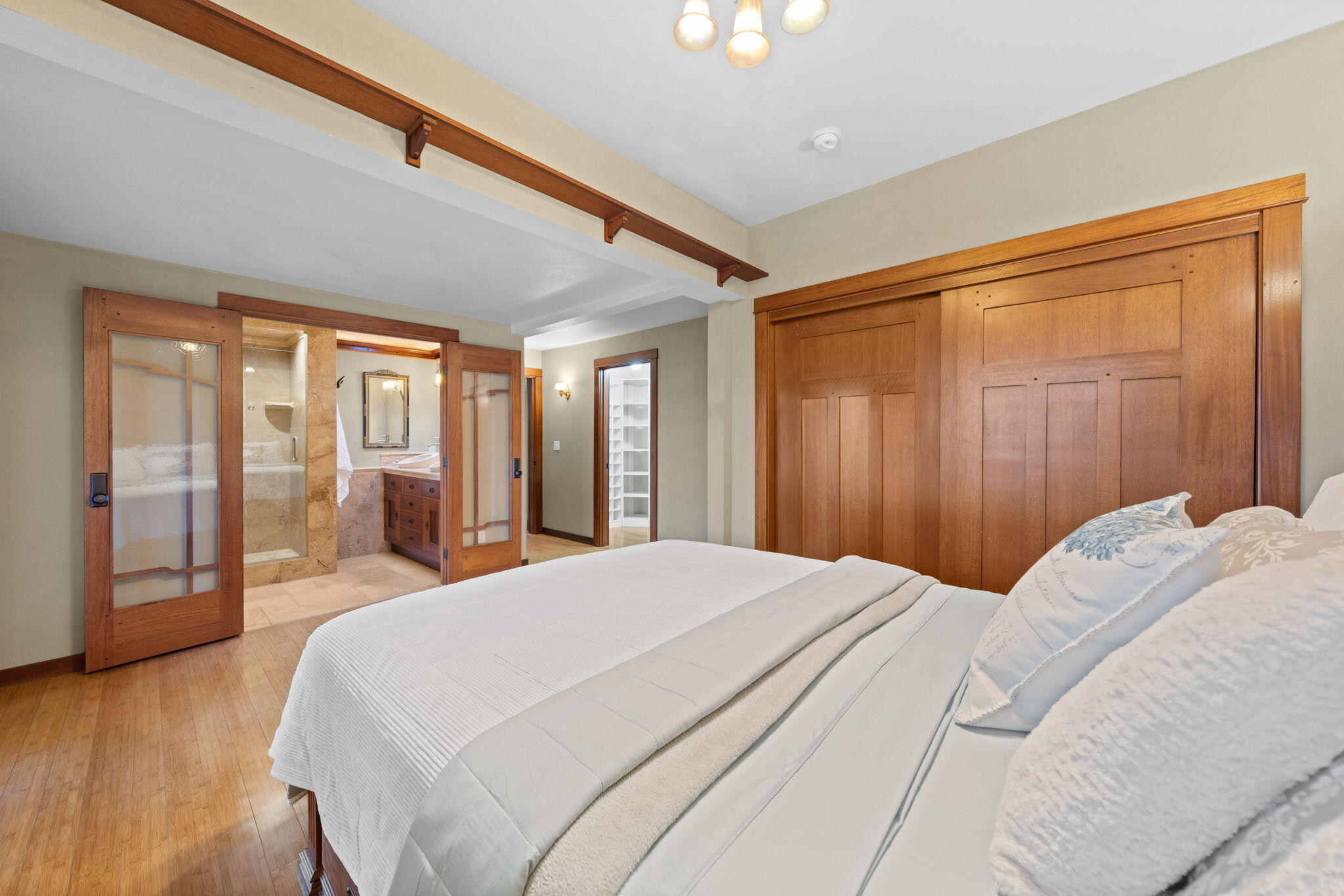 21925 Bear Creek Road Bend, OR 97702 - Photo 38 of 104 a bedroom with a large bed and a large window