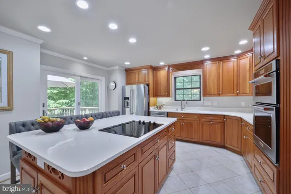 a kitchen with a sink a counter top space and stainless steel appliances