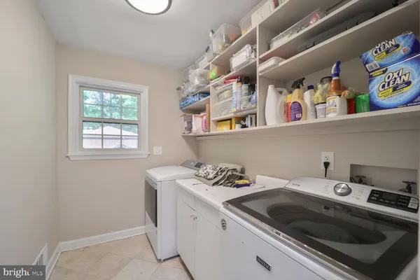 a kitchen that has a lot of cabinets a sink and a stove in it