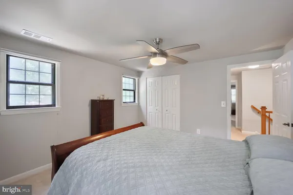 a bedroom with a large bed and a chandelier