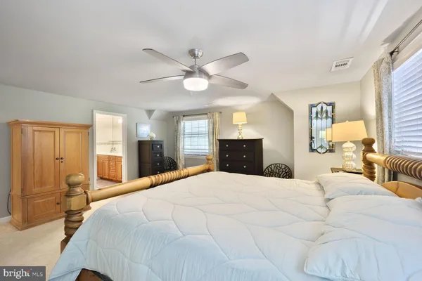 a spacious bedroom with a bed and a chandelier