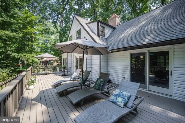 a front of a house with a yard and large trees