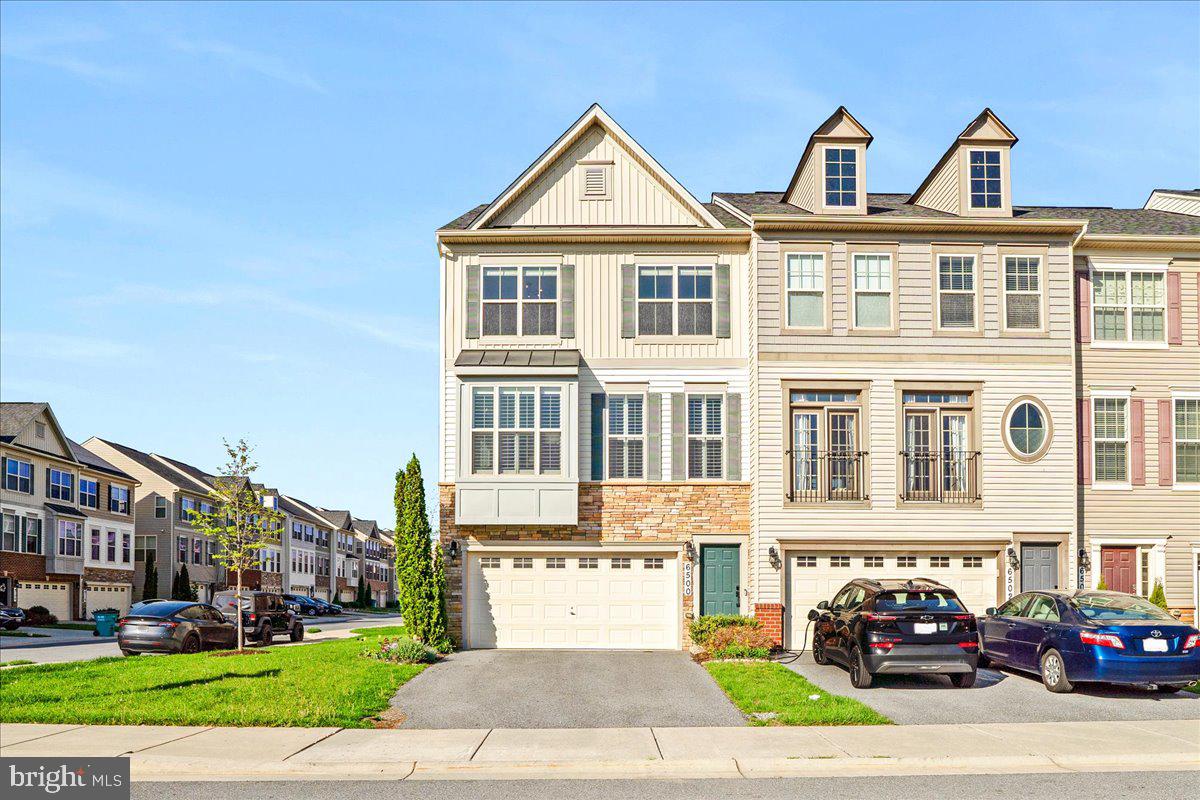 a front view of a residential apartment building with a yard