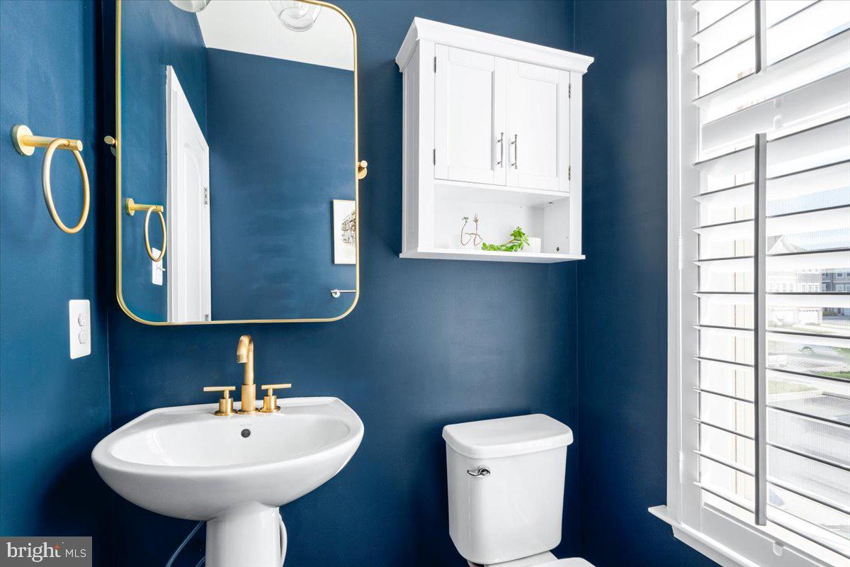 6500 Newton Drive Frederick, MD 21703 - Photo 14 of 36 a bathroom with a toilet sink and mirror